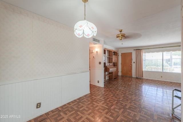 5228 E Des Moines St, Mesa, AZ 85205 - spare room with baseboards, a ceiling fan, and a wainscoted wall