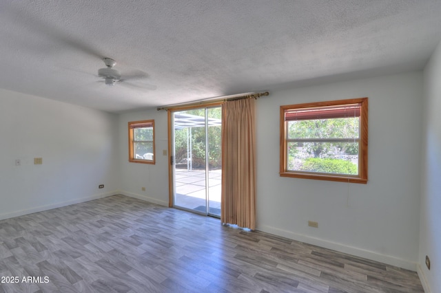 5228 E Des Moines St, Mesa, AZ 85205 - unfurnished room featuring ceiling fan, a textured ceiling, wood finished floors, and baseboards