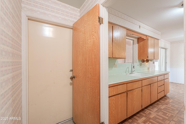 5228 E Des Moines St, Mesa, AZ 85205 - kitchen with wallpapered walls, a sink, light countertops, and wainscoting