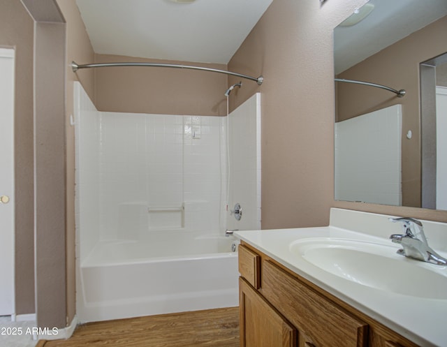 full bath featuring shower / tub combination, wood finished floors, and vanity