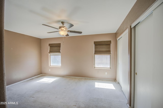 interior space with carpet and a ceiling fan