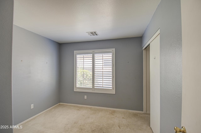 unfurnished bedroom featuring carpet floors, visible vents, and baseboards