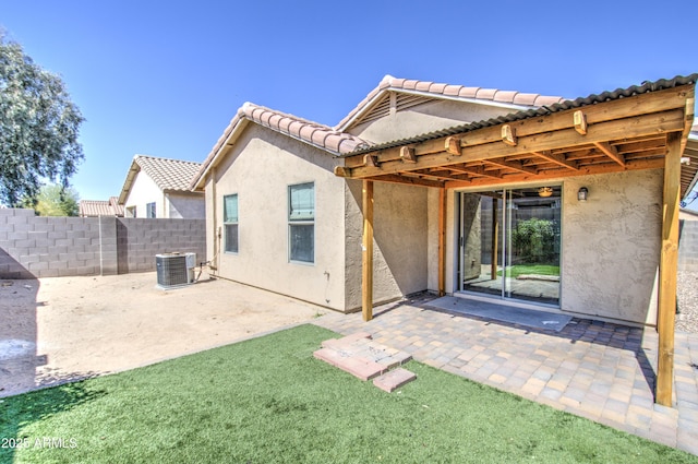 back of house with a patio, fence, central AC unit, and stucco siding