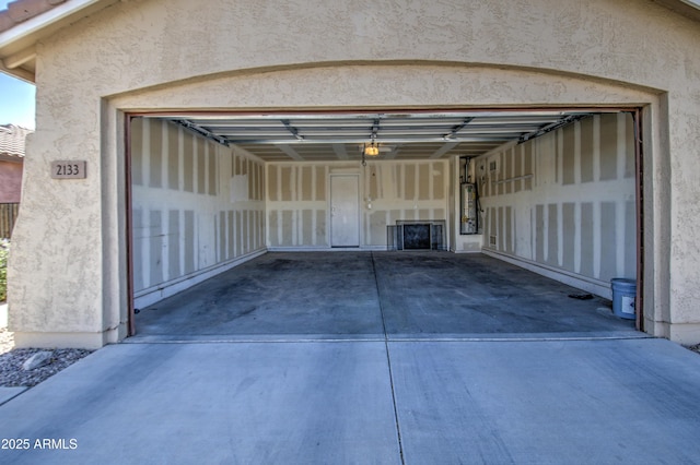 garage with driveway and gas water heater