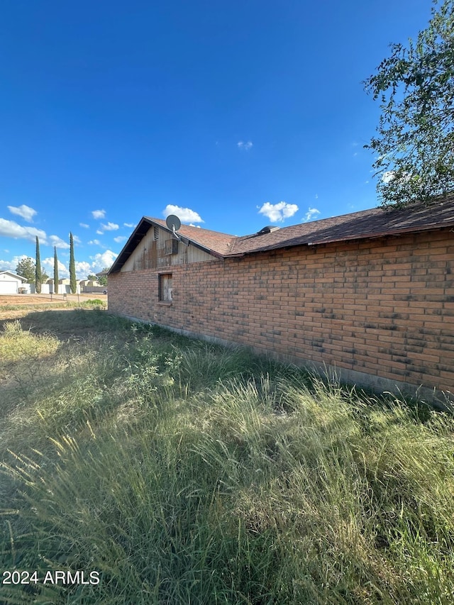 view of side of property featuring brick siding