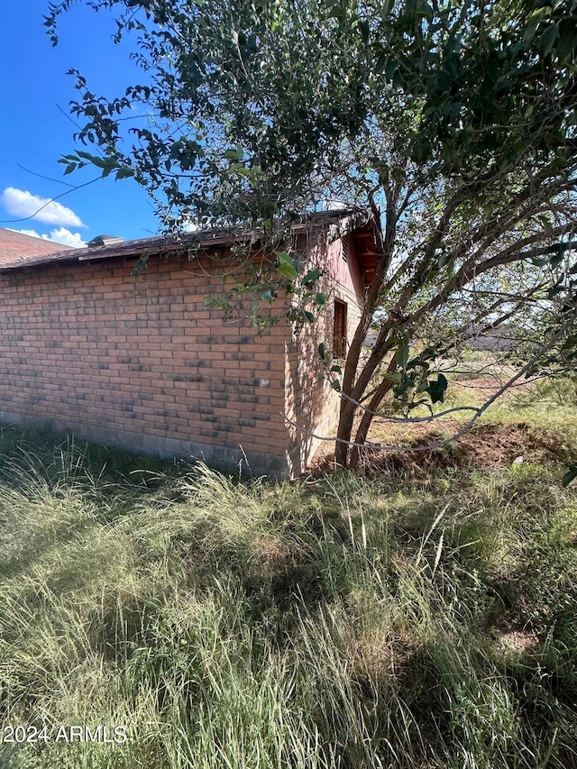view of side of property with brick siding
