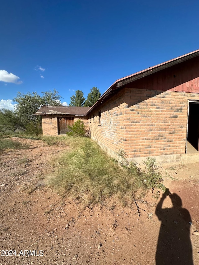 view of home's exterior with brick siding