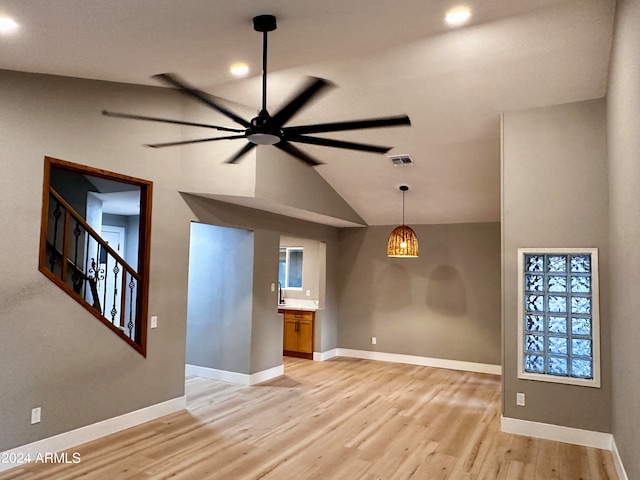 interior space featuring ceiling fan, light wood-type flooring, and vaulted ceiling