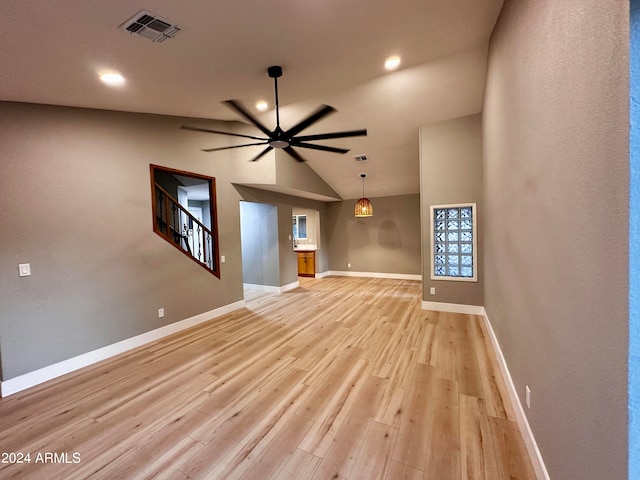 unfurnished living room with light wood-type flooring, lofted ceiling, and ceiling fan