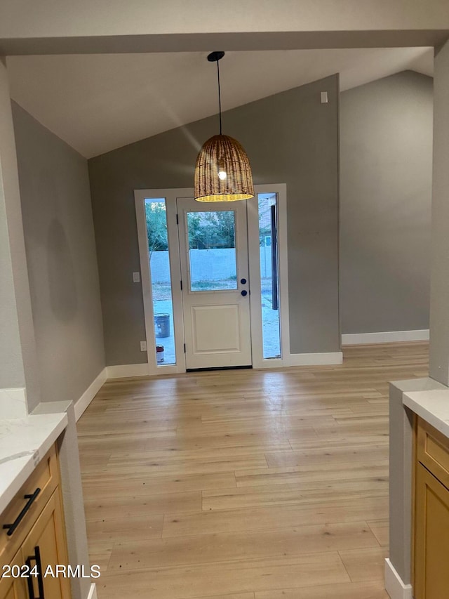 foyer entrance featuring light hardwood / wood-style flooring and lofted ceiling