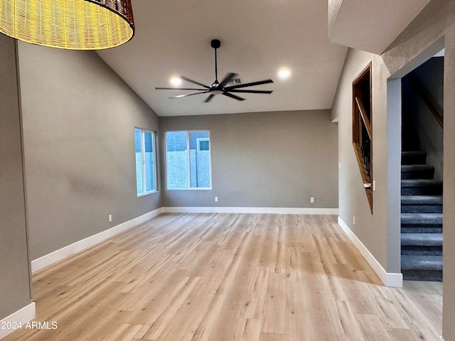 empty room with light hardwood / wood-style floors, lofted ceiling, and ceiling fan