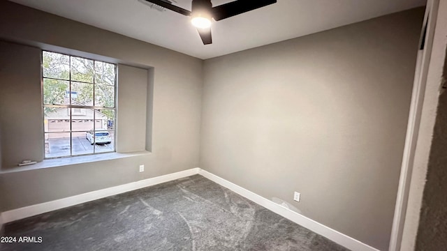 carpeted empty room featuring ceiling fan