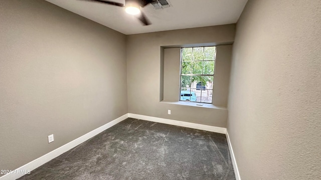 carpeted spare room with ceiling fan