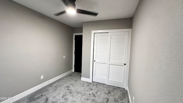 unfurnished bedroom with light carpet, a closet, and ceiling fan