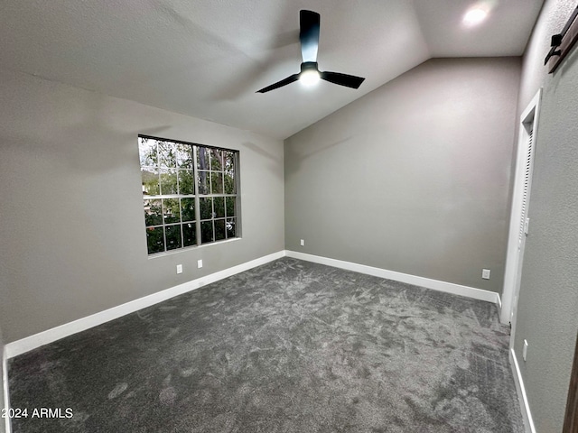 carpeted empty room featuring lofted ceiling and ceiling fan