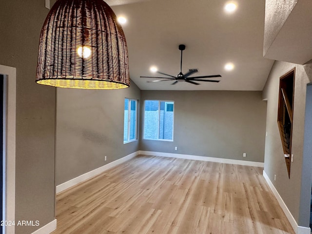 unfurnished room with light wood-type flooring, lofted ceiling, and ceiling fan