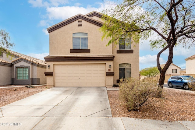 view of front of home featuring a tiled roof, stucco siding, driveway, and a garage