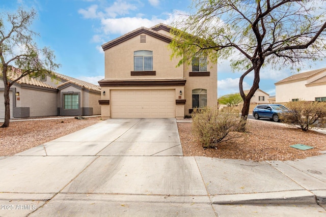 view of front facade featuring a tile roof, an attached garage, driveway, and stucco siding