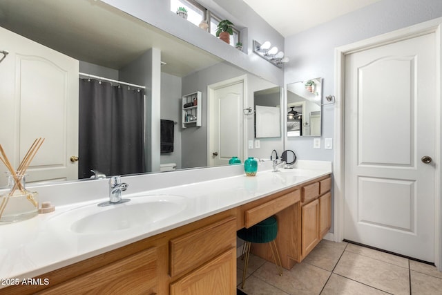 full bathroom featuring tile patterned floors, toilet, double vanity, and a sink