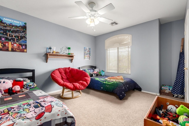 carpeted bedroom with visible vents, baseboards, and ceiling fan