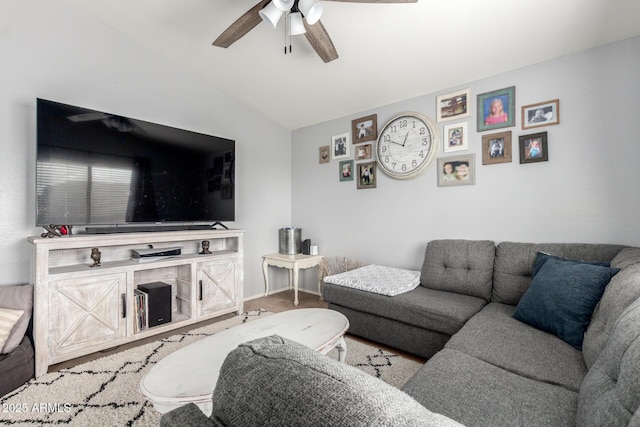 living room with lofted ceiling, a ceiling fan, and baseboards