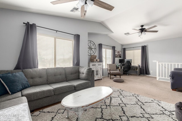 living room featuring visible vents, a ceiling fan, and vaulted ceiling