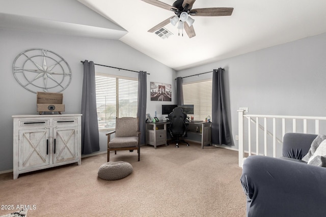 office area with baseboards, visible vents, lofted ceiling, ceiling fan, and light colored carpet