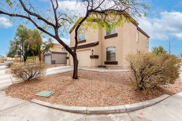 view of front of property featuring stucco siding, driveway, and an attached garage