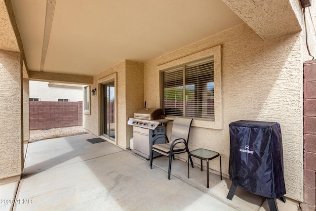 view of patio featuring fence and grilling area