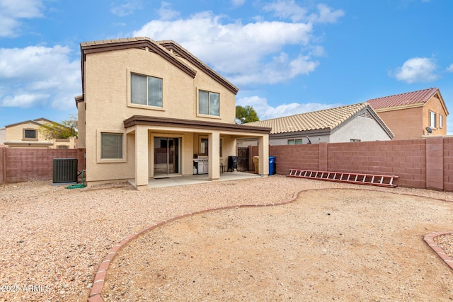 back of house featuring stucco siding, central AC unit, a fenced backyard, and a patio area