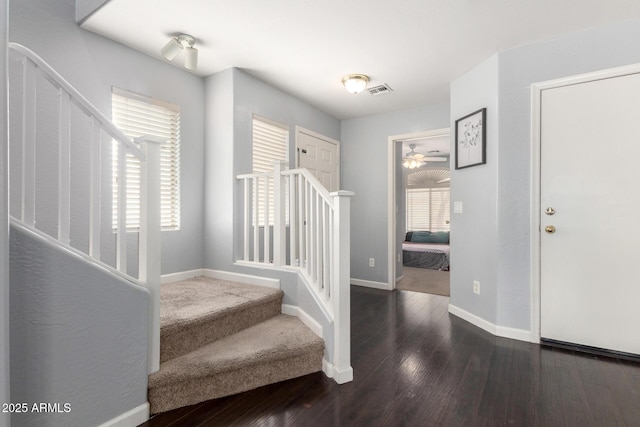 entrance foyer featuring stairway, a ceiling fan, baseboards, and wood finished floors