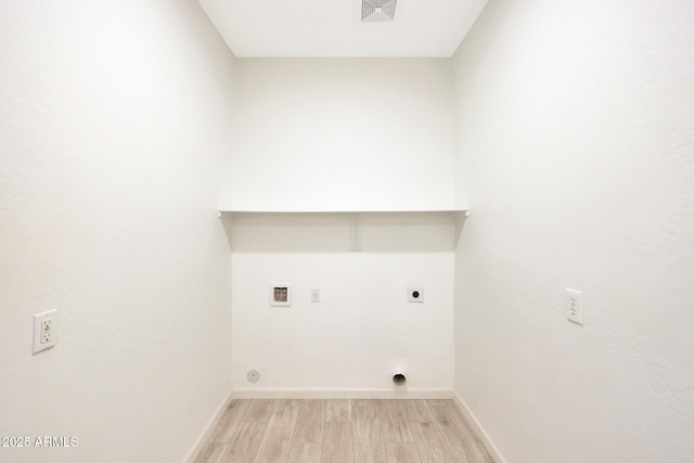 clothes washing area with washer hookup, light hardwood / wood-style flooring, and hookup for an electric dryer