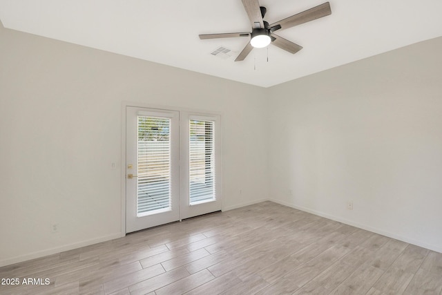 spare room featuring light hardwood / wood-style flooring and ceiling fan