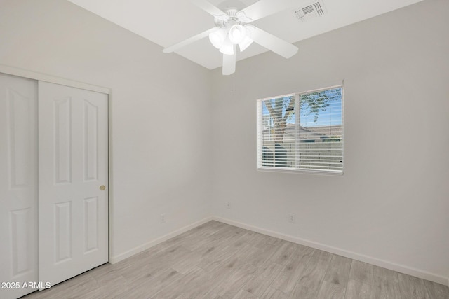 unfurnished bedroom with a closet and light hardwood / wood-style flooring