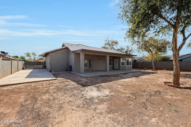 rear view of property featuring a patio area