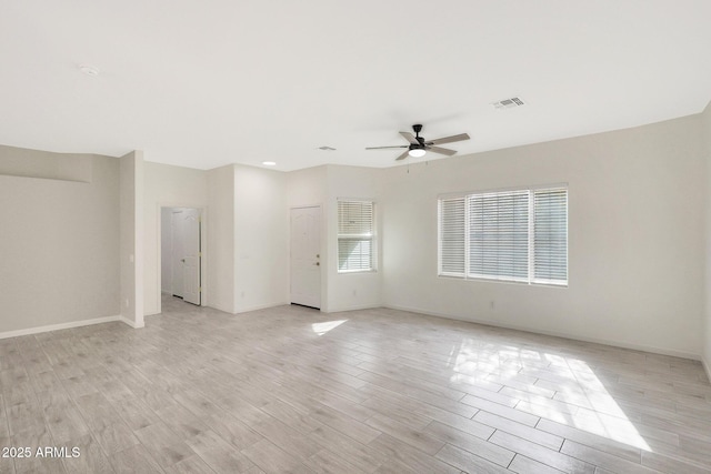 empty room with ceiling fan and light wood-type flooring