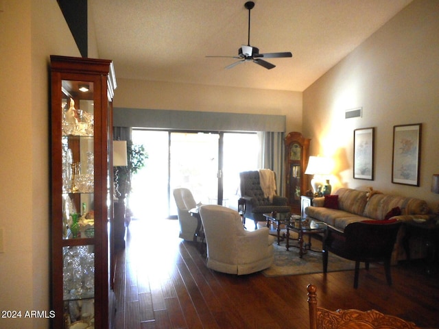 living room with ceiling fan, dark hardwood / wood-style flooring, and vaulted ceiling