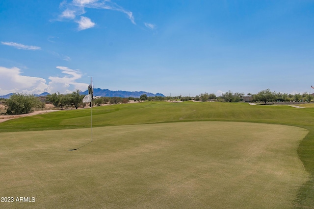 view of home's community featuring a lawn and a mountain view