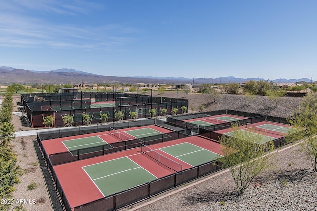 view of tennis court featuring a mountain view