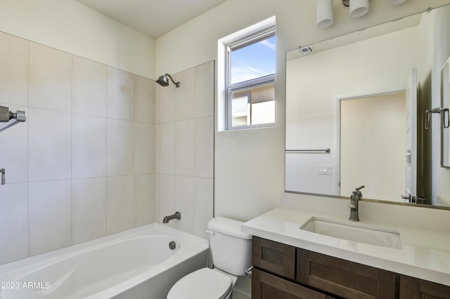 full bathroom featuring vanity, tiled shower / bath combo, and toilet