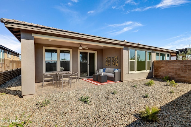 back of house with ceiling fan and a patio