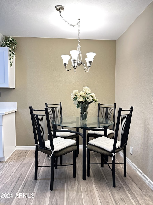 dining room with a notable chandelier and light hardwood / wood-style floors