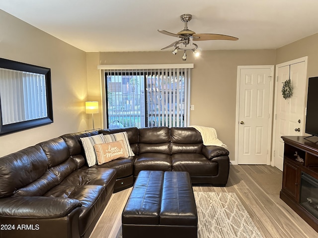 living room with hardwood / wood-style floors and ceiling fan