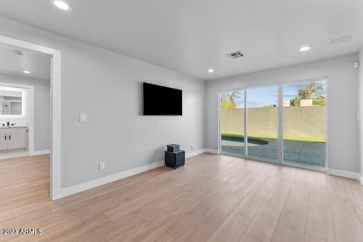 unfurnished living room with light hardwood / wood-style flooring