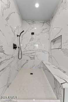 bathroom featuring tiled shower