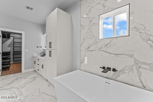 bathroom featuring a bath and vanity