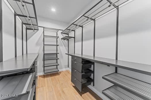 spacious closet featuring light hardwood / wood-style floors