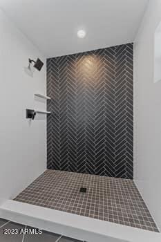 bathroom with tiled shower