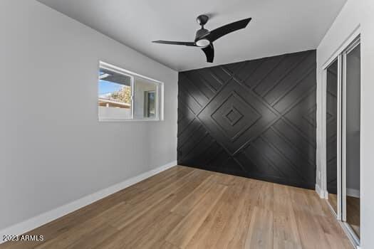 spare room featuring hardwood / wood-style floors and ceiling fan