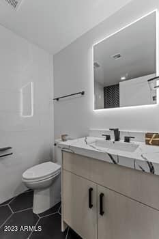 bathroom with tile patterned floors, toilet, and vanity